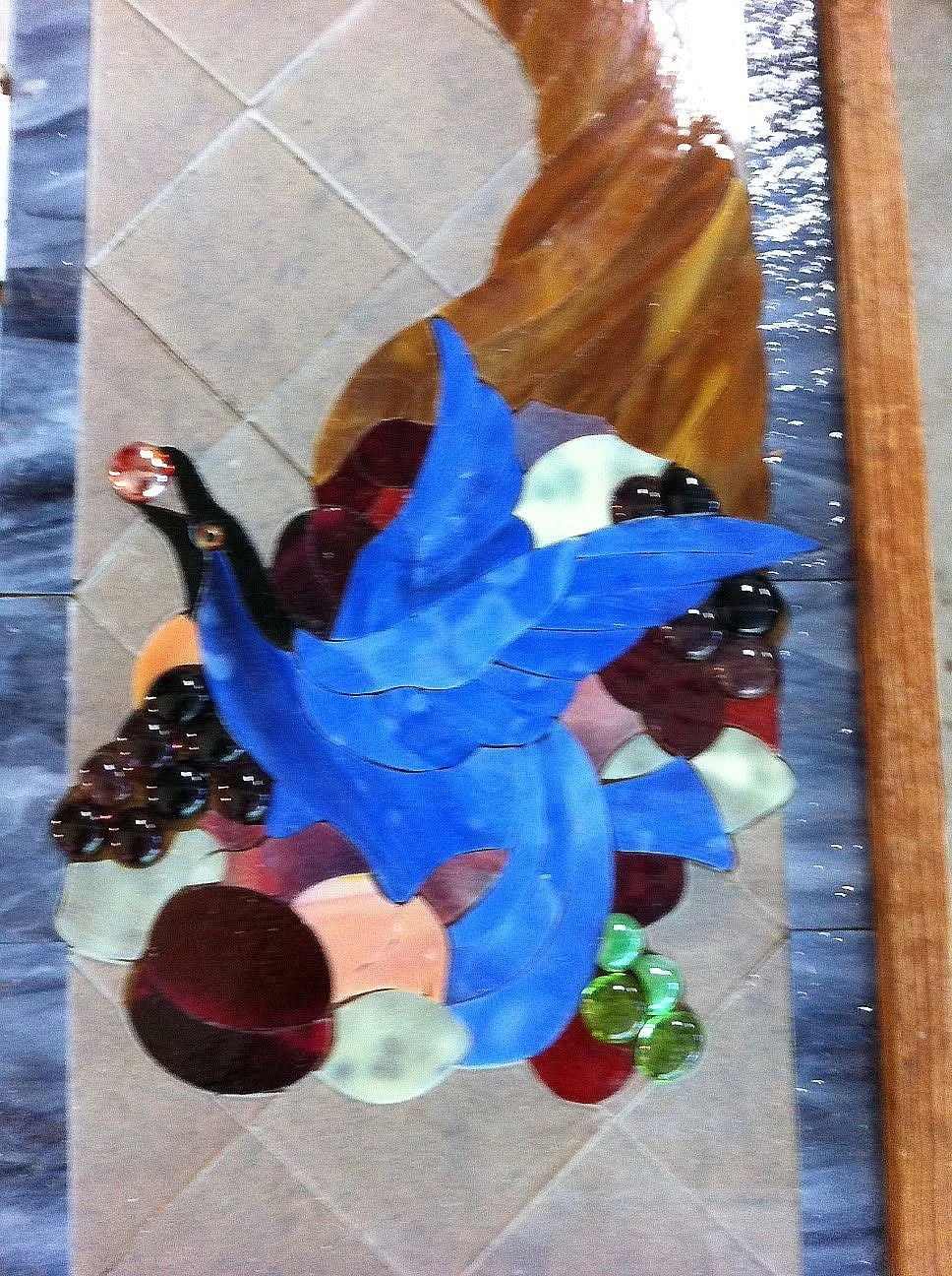 Close-up of the bird and cornucopia glass layout