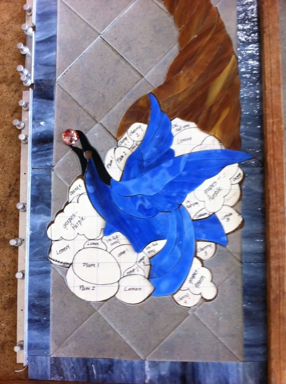 Blue bird glass laid over the paper pattern