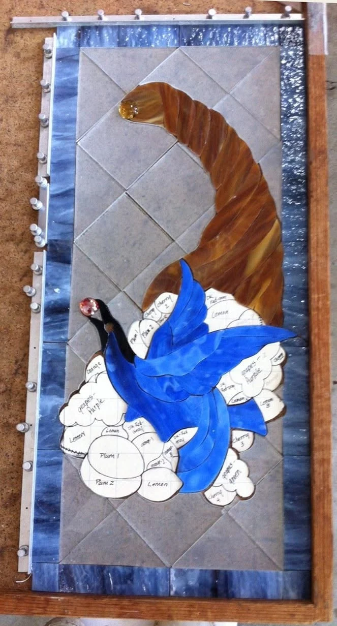 Bird and cornucopia layout with paper shapes still visible