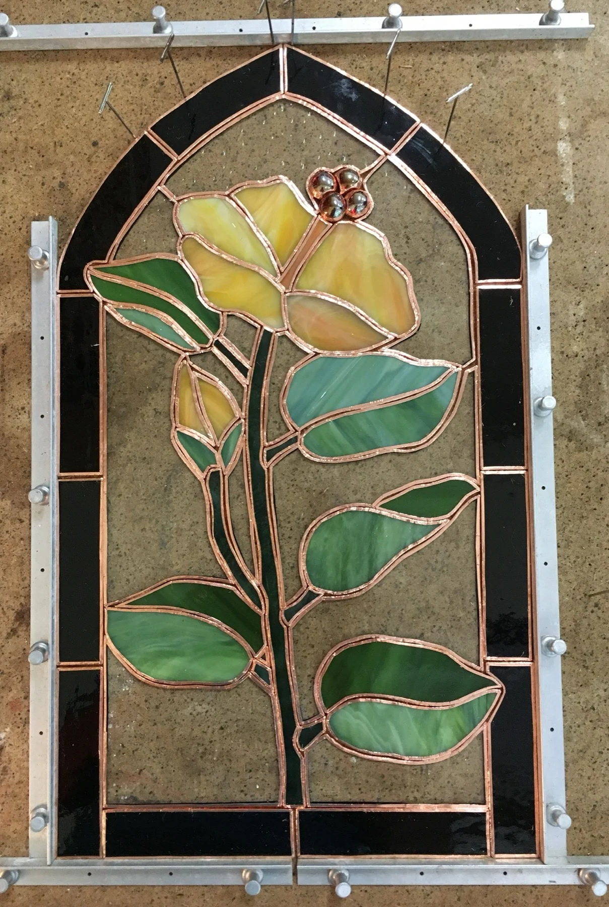 Yellow rose panel with visible copper foil during assembly