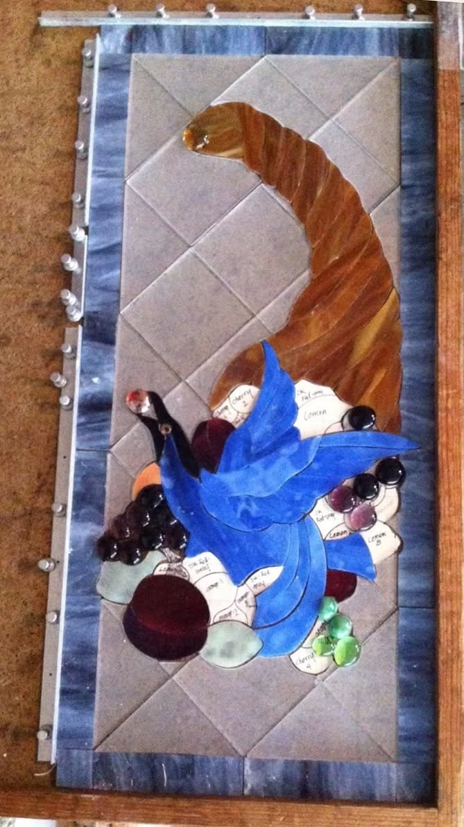 Developing composition with blue bird and colored fruit